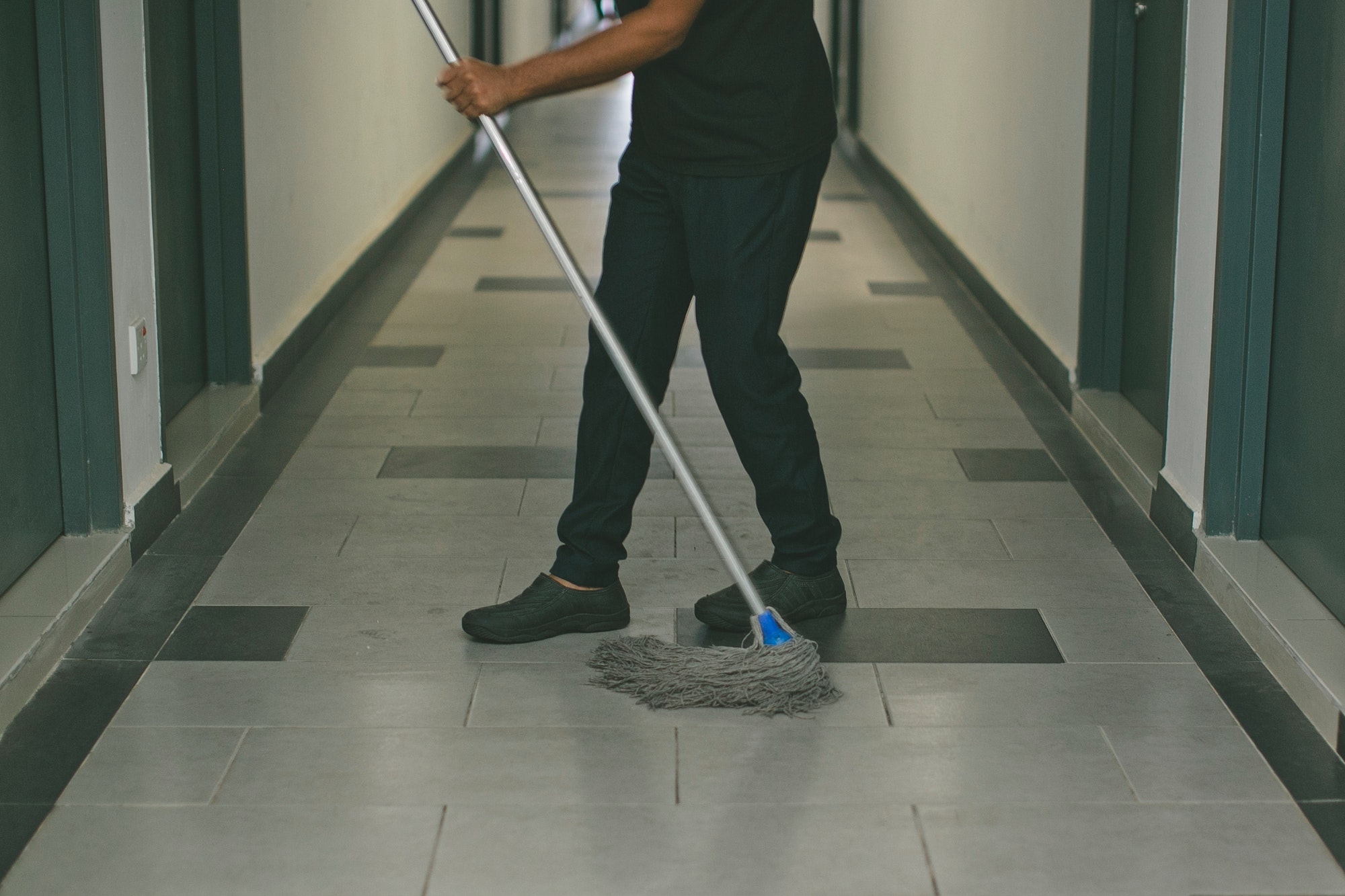 Housekeeper cleaning the floor
