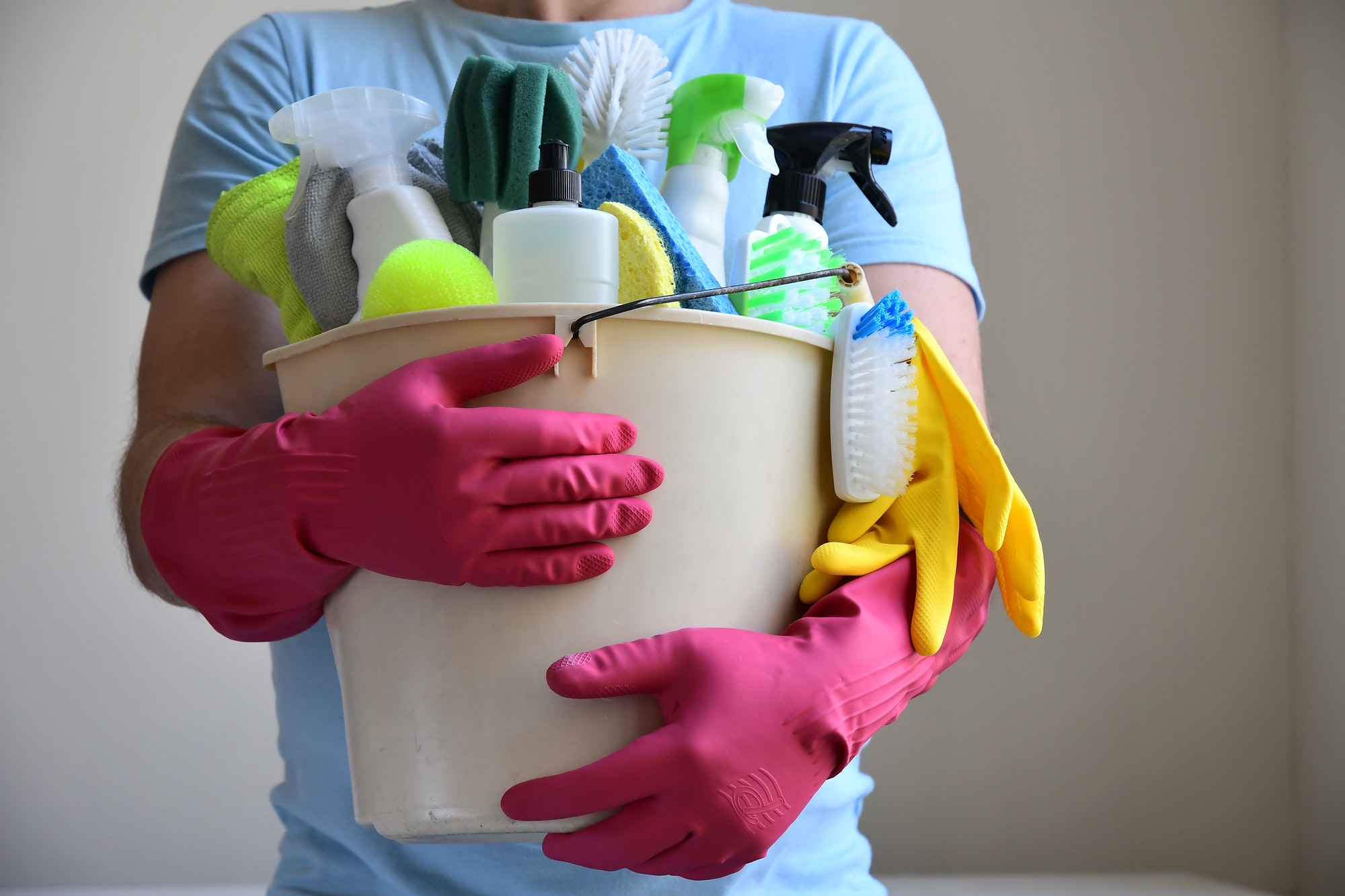 Person holding cleaning products